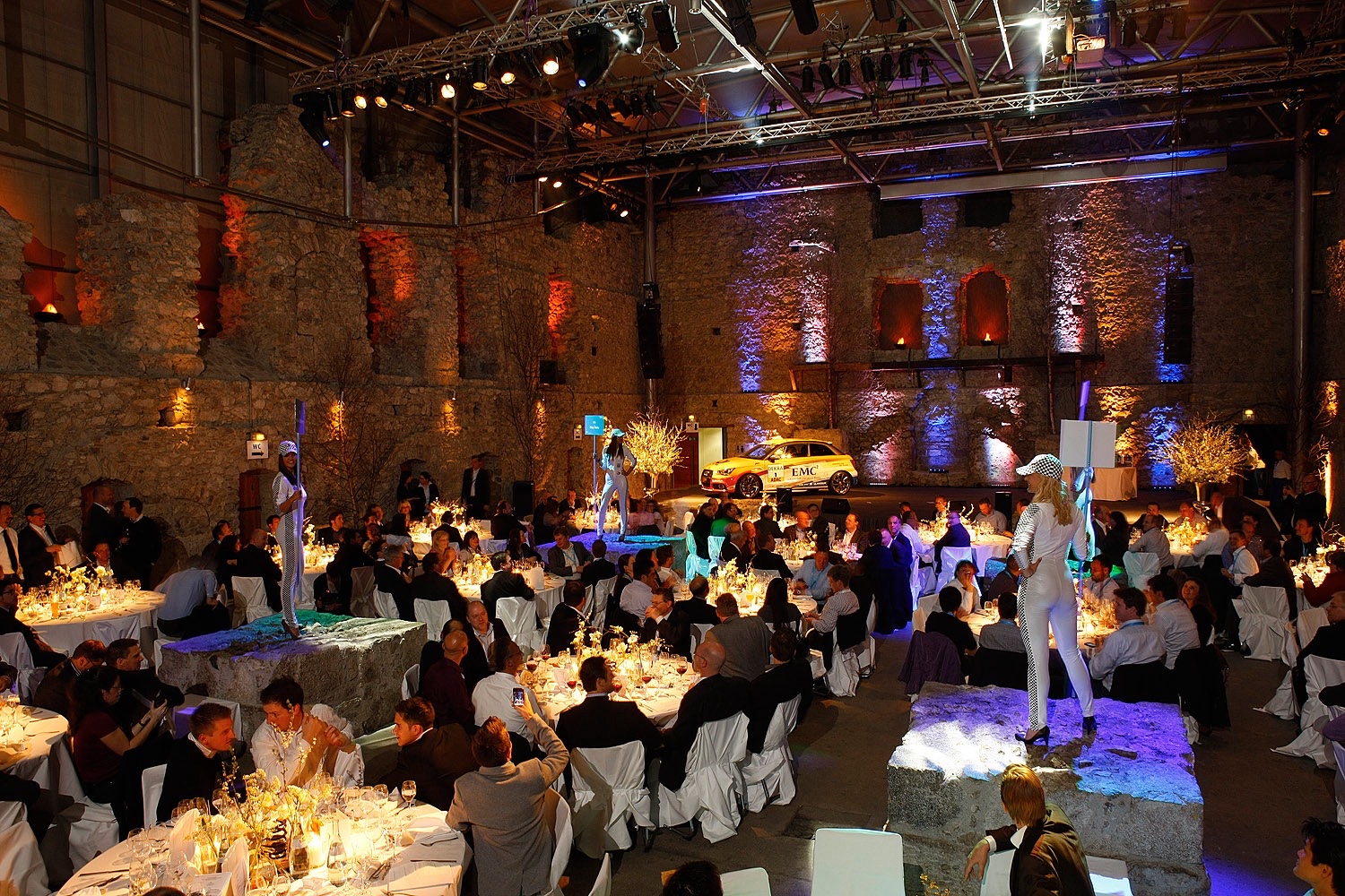 Abendveranstaltung beim EMC Sales- und Partnerevent Festlich gedeckter Veranstaltungssaal mit Teilnehmern und Bühne beim EMC Partner-Event
