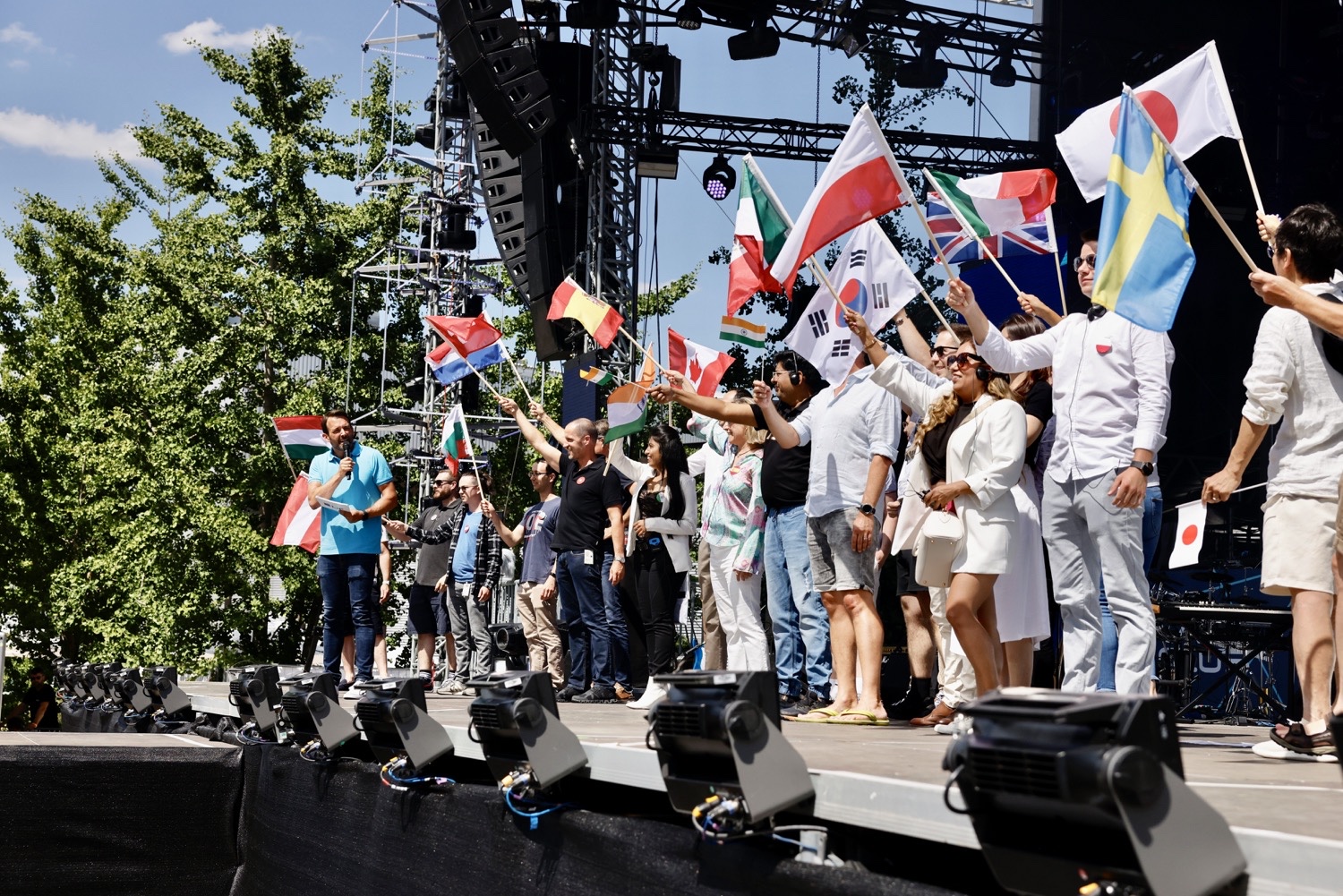 World Wide Moment at the TRUMPF 100 Festival Participants holding national flags on the live stage during the international World Wide Moment at the TRUMPF 100 Festival